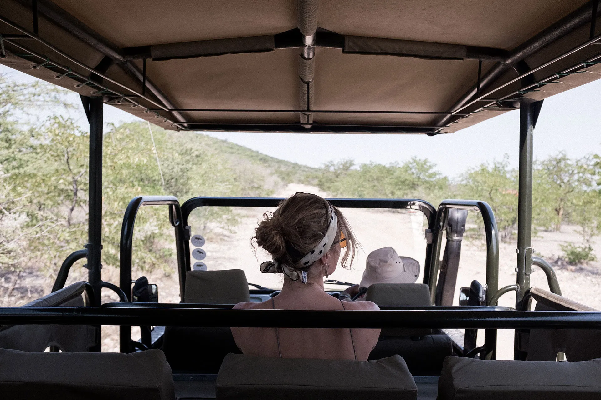 Frau sitzt auf Jeep
