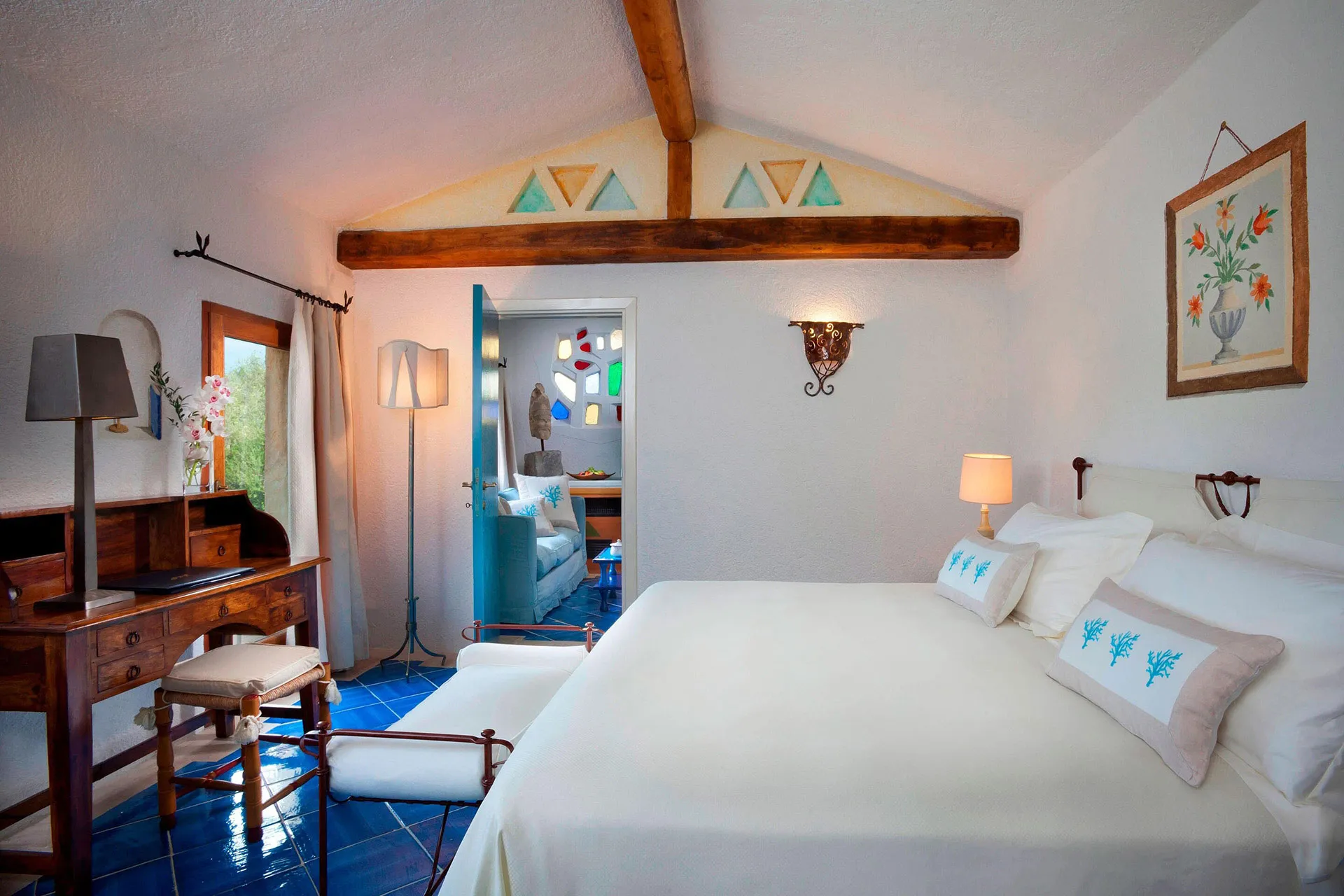 Zimmer mit blauen Bodenfliesen und antiken Möbeln