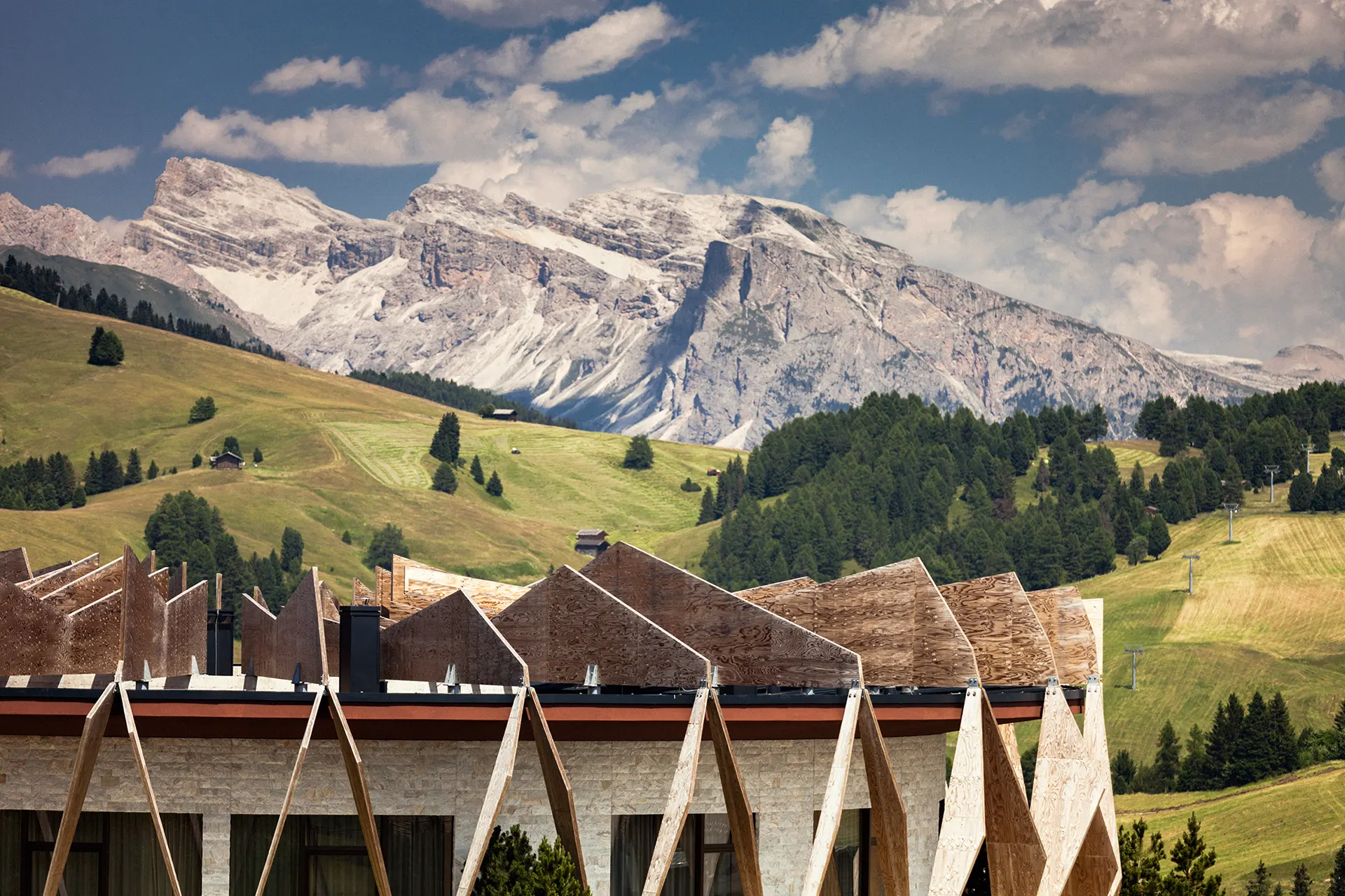 Fassade eines alpinen Hotels vor Bergkulisse