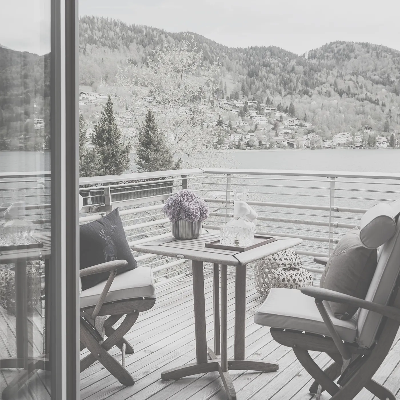 Zwei Stühle mit Tisch auf Terrasse mit Seeblick